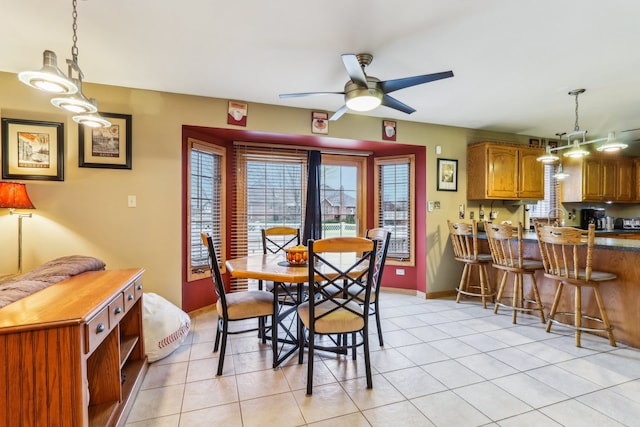 tiled dining area with ceiling fan