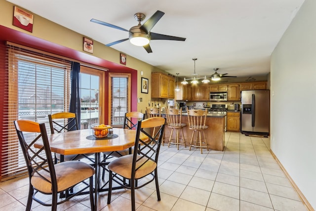 tiled dining area featuring ceiling fan