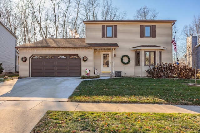 front of property with a front yard and a garage