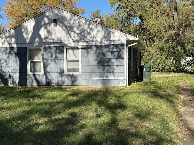 view of property exterior with a lawn