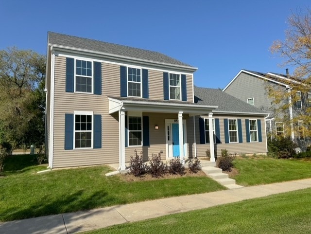 colonial home with a front lawn