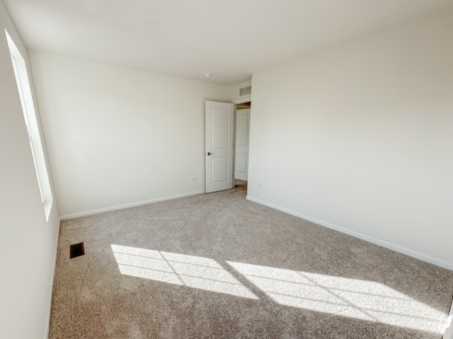 spare room featuring carpet