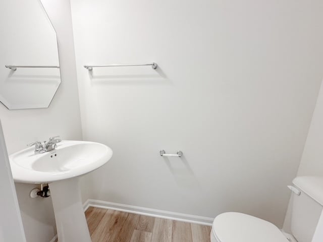 bathroom featuring hardwood / wood-style floors, toilet, and sink