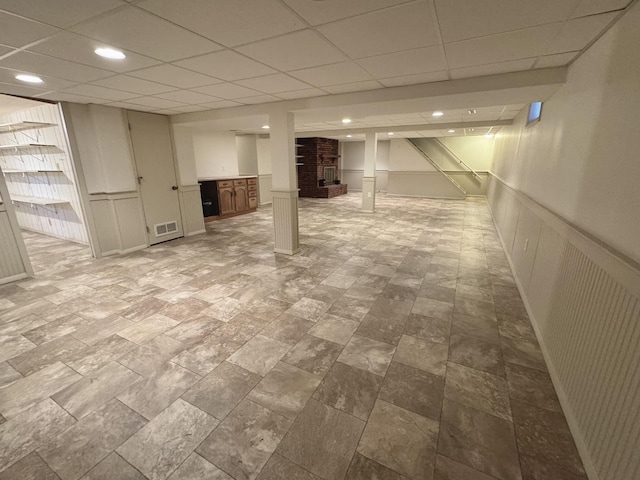 basement with a paneled ceiling