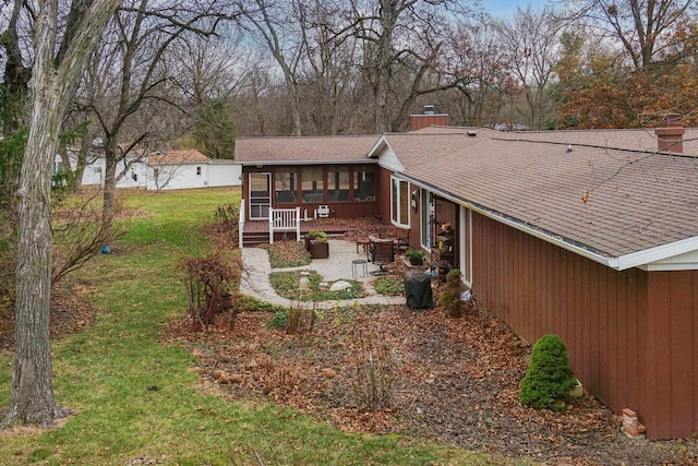 view of yard featuring a patio and a sunroom