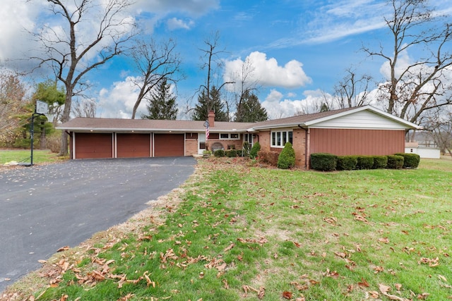 ranch-style house with a front lawn and a garage