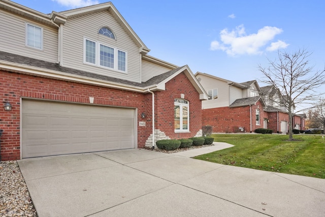 view of front property featuring a garage and a front lawn