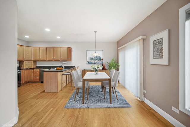 dining space featuring light wood-type flooring