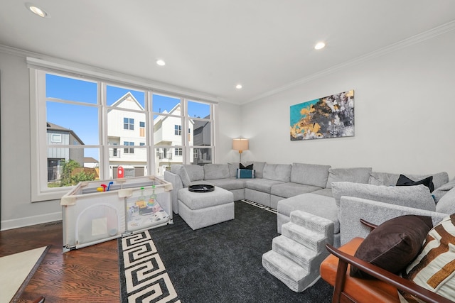 living room with a wealth of natural light, dark wood-type flooring, and ornamental molding