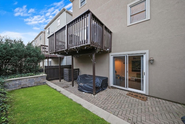 back of house with a patio area, a yard, and a balcony