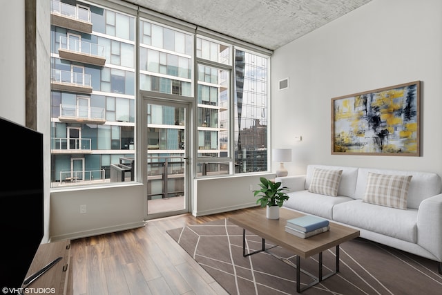 living room featuring hardwood / wood-style floors and a high ceiling