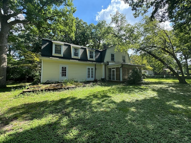 back of house with a lawn and french doors