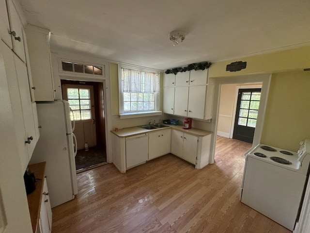 kitchen with white appliances, light hardwood / wood-style flooring, white cabinetry, and sink