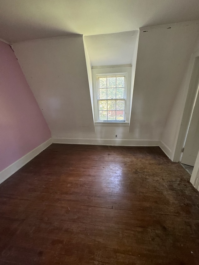 empty room featuring dark hardwood / wood-style floors and vaulted ceiling