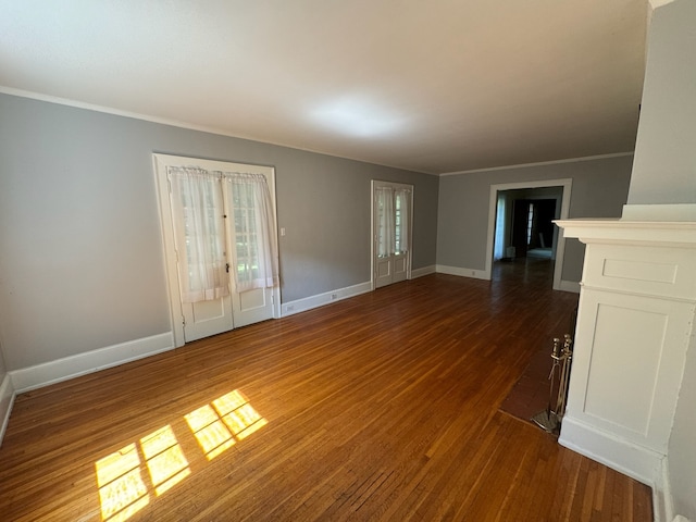 spare room with crown molding and dark hardwood / wood-style flooring