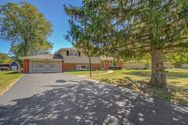 split level home featuring a front lawn and a garage