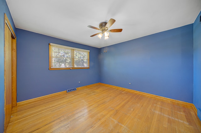 unfurnished bedroom with a closet, hardwood / wood-style floors, and ceiling fan