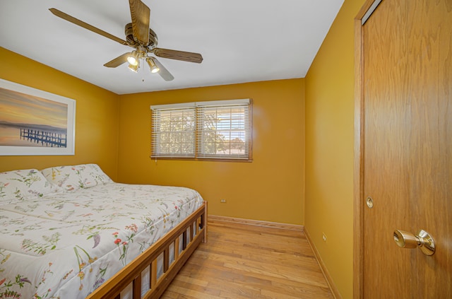 bedroom with ceiling fan, a closet, and light hardwood / wood-style floors