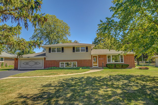 split level home featuring a garage and a front lawn