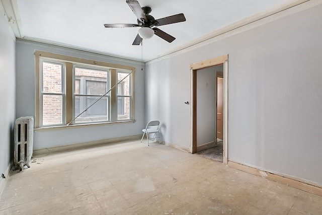 spare room with crown molding, radiator heating unit, and ceiling fan