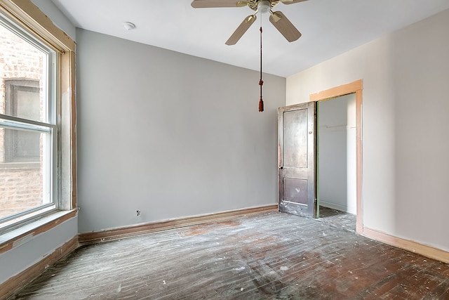 unfurnished room featuring ceiling fan and dark wood-type flooring