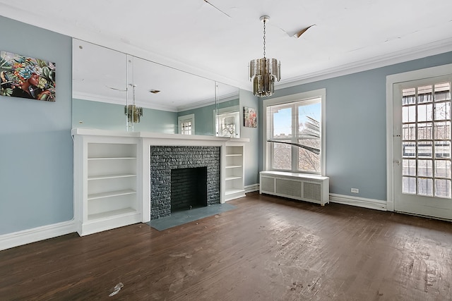 unfurnished living room featuring an inviting chandelier, a brick fireplace, ornamental molding, dark hardwood / wood-style flooring, and radiator heating unit