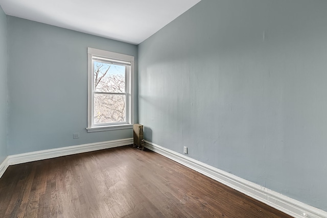 unfurnished room with hardwood / wood-style flooring