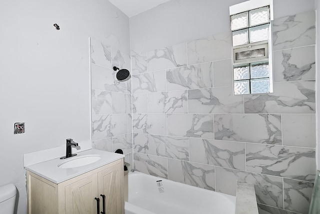 bathroom featuring plenty of natural light, toilet, and vanity