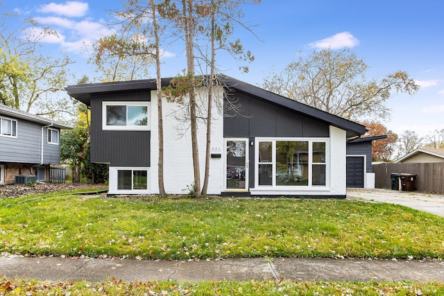 view of front of house featuring a front lawn and central air condition unit