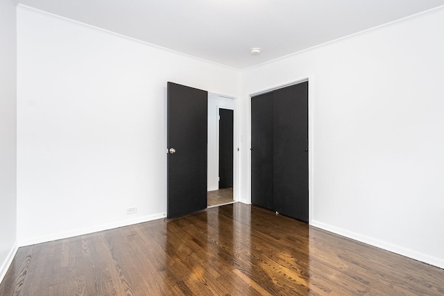 unfurnished room with dark hardwood / wood-style floors and crown molding