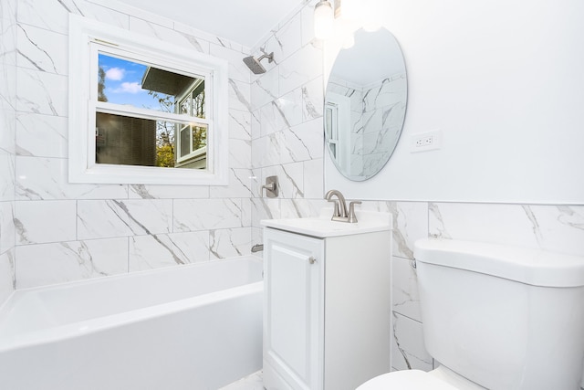 full bathroom featuring vanity, tiled shower / bath combo, toilet, and tile walls