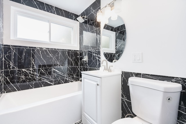 full bathroom with vanity, bathtub / shower combination, tile walls, and toilet