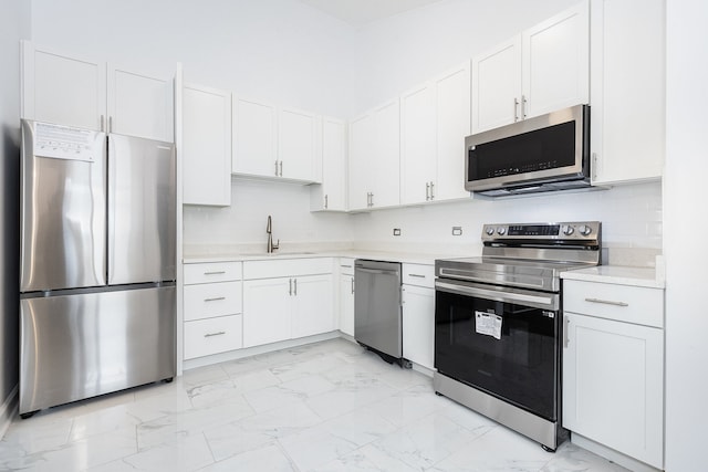 kitchen with white cabinetry, sink, and appliances with stainless steel finishes