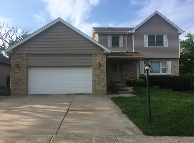 view of front of house with a front yard and a garage