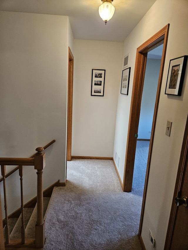 corridor with light colored carpet