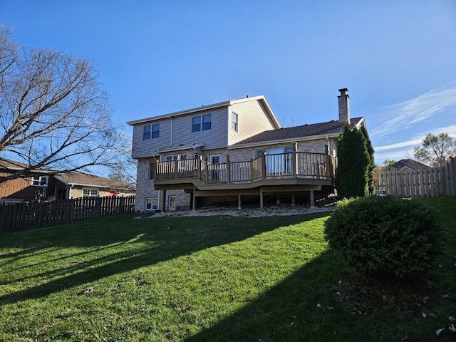 rear view of property featuring a deck and a yard