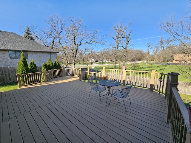 wooden terrace featuring a yard