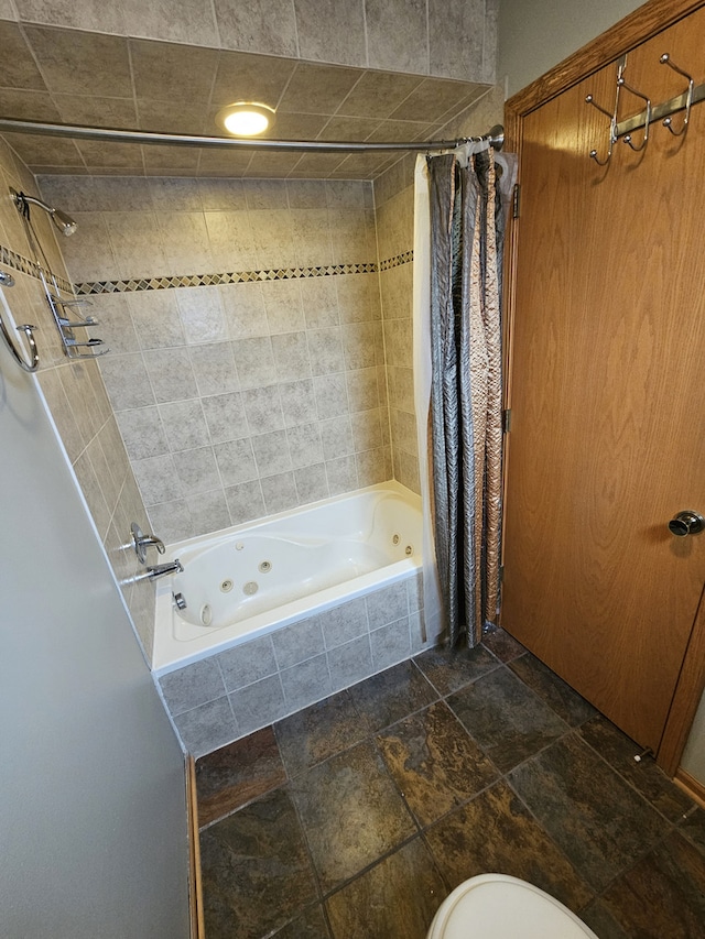 bathroom featuring toilet and shower / bath combo with shower curtain