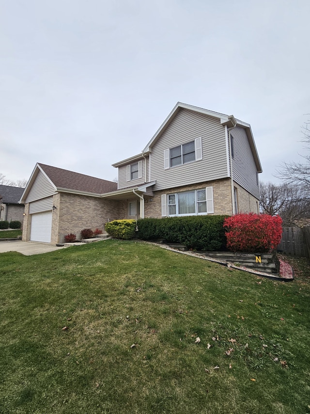 view of property featuring a front yard and a garage