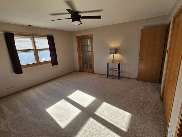 empty room featuring light carpet and ceiling fan