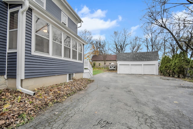 view of side of property featuring a garage and an outdoor structure