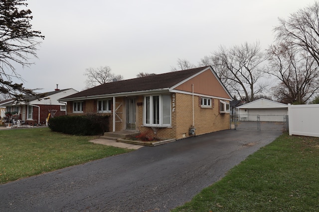 view of front facade featuring a garage, an outdoor structure, and a front yard