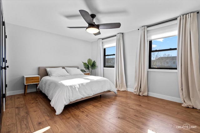 bedroom featuring ceiling fan and hardwood / wood-style flooring