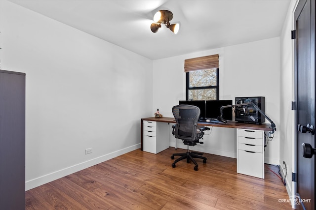 home office with wood-type flooring