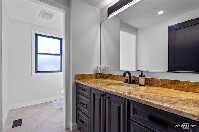 bathroom featuring tile patterned floors, vanity, and toilet