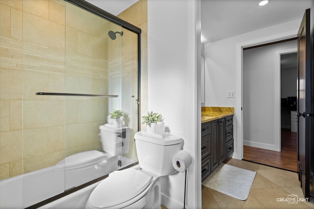 bathroom featuring tile patterned floors, vanity, and toilet