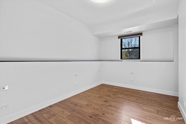 unfurnished room with hardwood / wood-style flooring