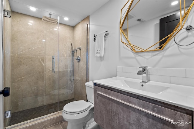 bathroom featuring tile patterned floors, vanity, toilet, and walk in shower