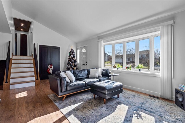 living room featuring dark wood-type flooring and lofted ceiling