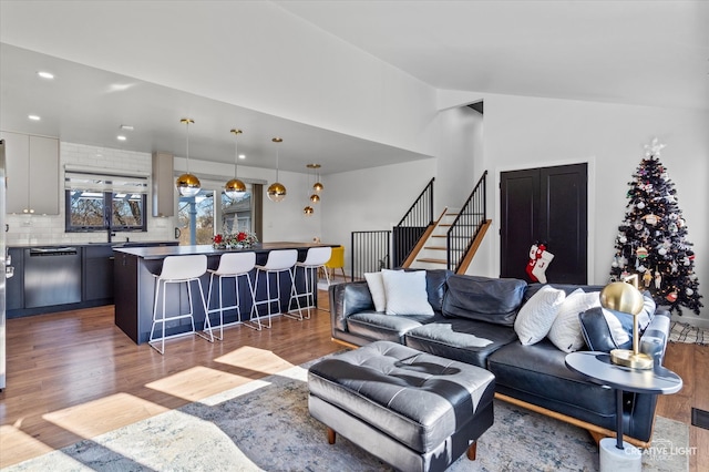 living room with dark hardwood / wood-style flooring and lofted ceiling